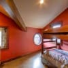 Kids room painted red with bunk beds