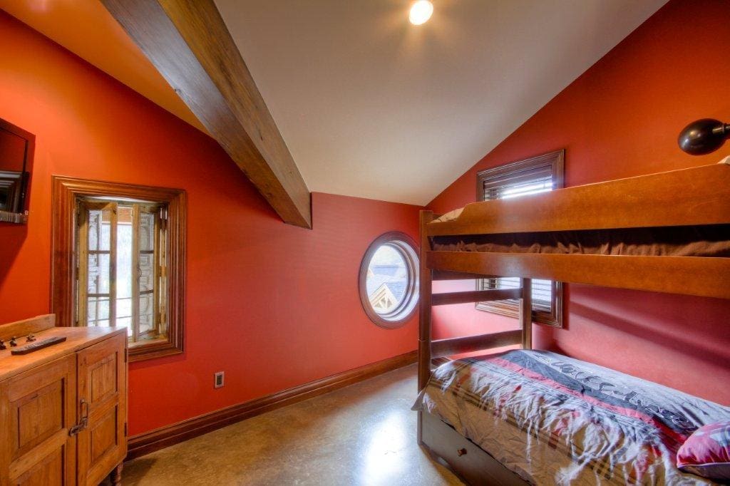 Kids room painted red with bunk beds