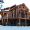 snow covered log home