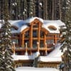 luxury log cabin covered in snow
