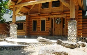 log cabin with beautiful rock entry way