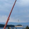 Log boom lowering beam into place