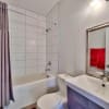 White bathroom with red accents in modern home