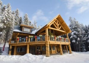 Outside of post and beam log home in the snow