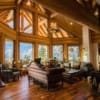 Open-concept living room in a post and beam log home