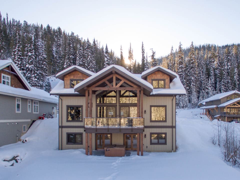 Outside view of a timber frame log home in the snow