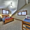 Second bedroom with vaulted ceilings in a timber frame log home