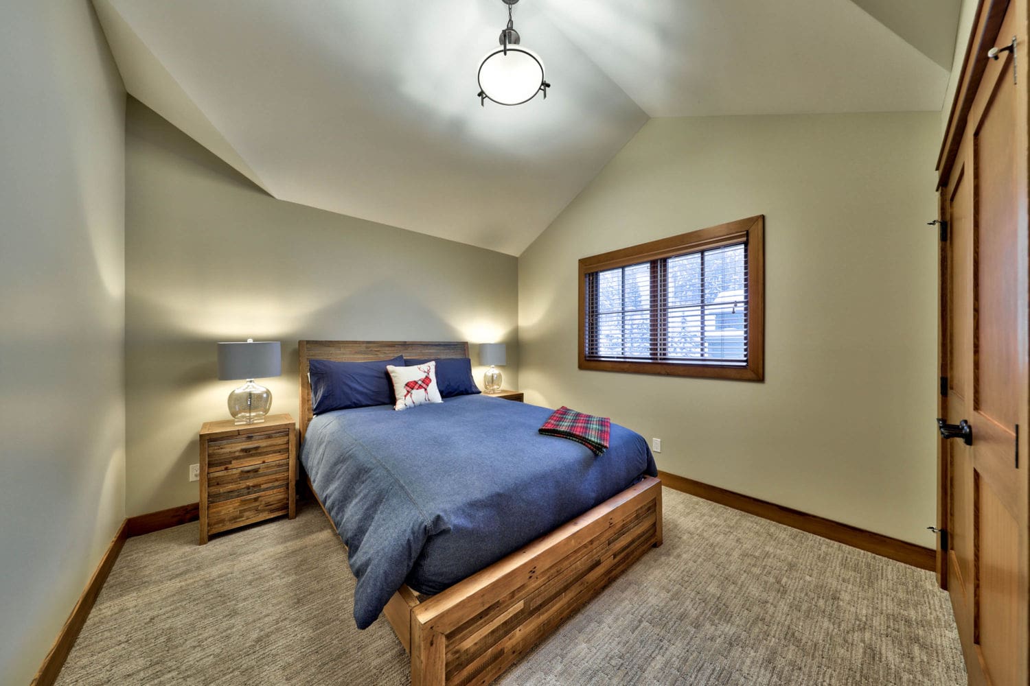 Third bedroom with vaulted ceilings in a timber frame log home