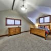 Fourth bedroom with vaulted ceilings in a timber frame log home