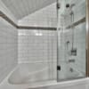Glass shower and tile bathtub in timber frame log home bathroom